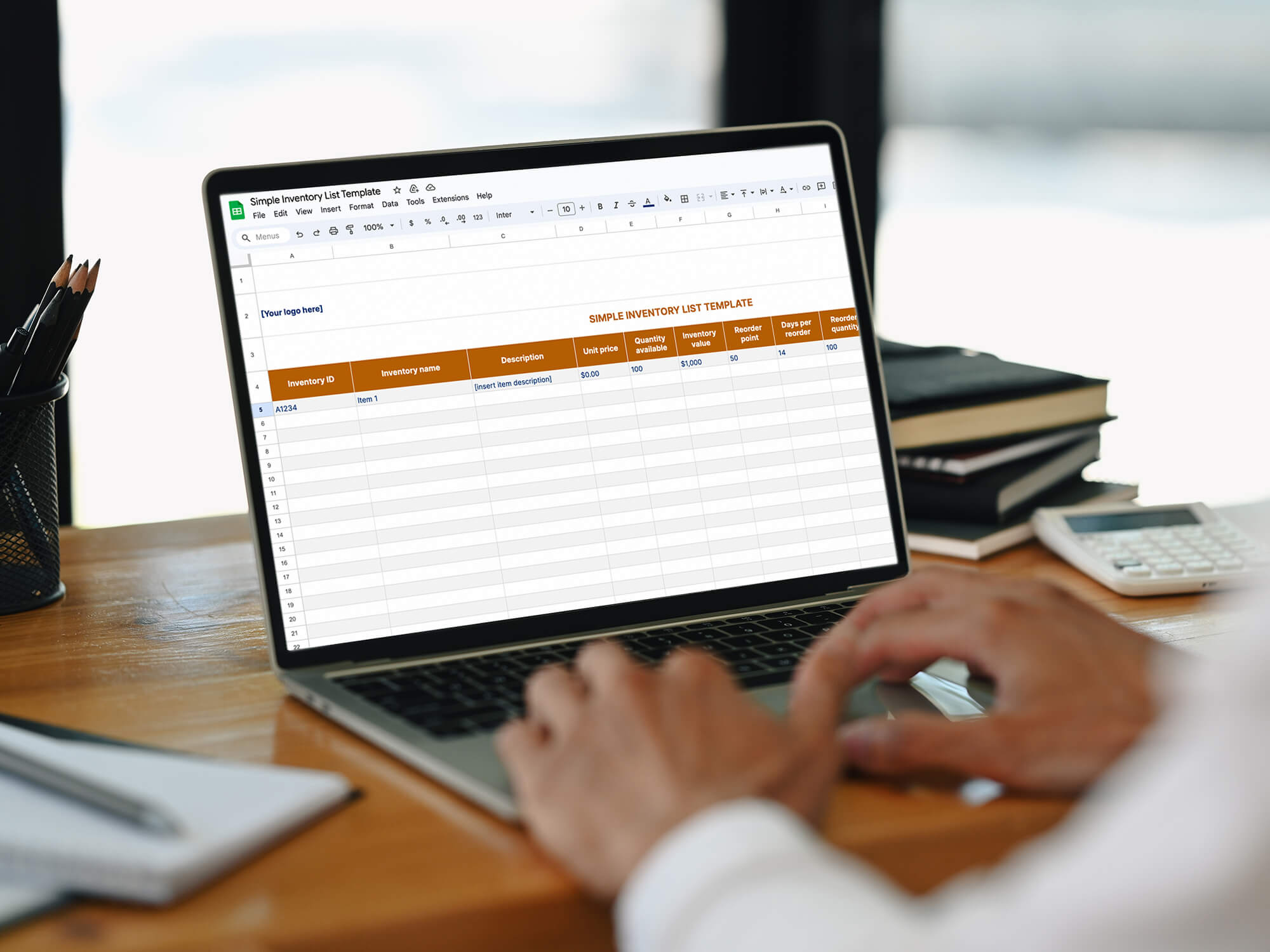 Someone works on a simple inventory list template on a desk